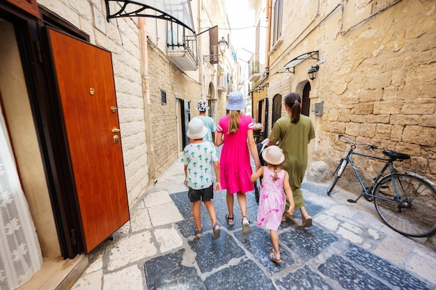 Family of tourists waking in streets Bari Puglia South Italy