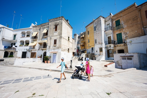 Family of tourists waking in streets Bari Puglia South Italy