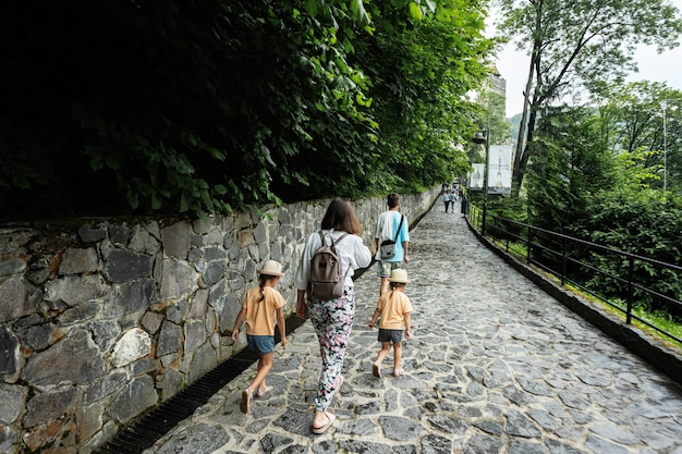 Family of tourists with children visit the old castle Bran Romania