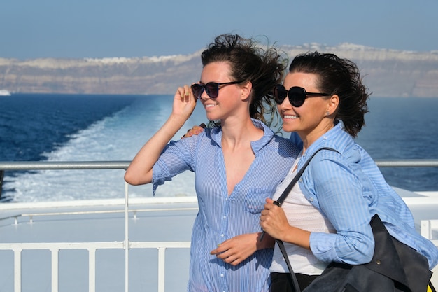 Family travel luxury cruise vacation, mother and teenage daughter enjoy sea trip on deck of liner on sunny summer day, copy space