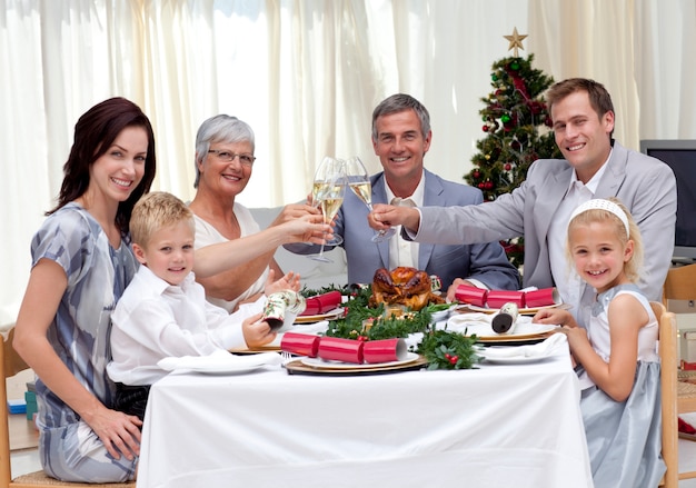 Family tusting in a Christmas dinner