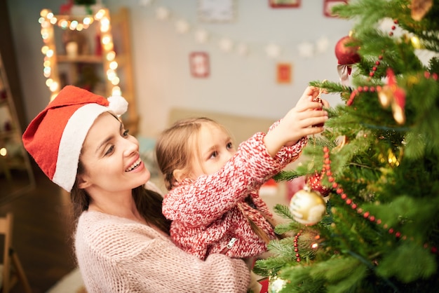 Family of Two Decorating Christmas Tree