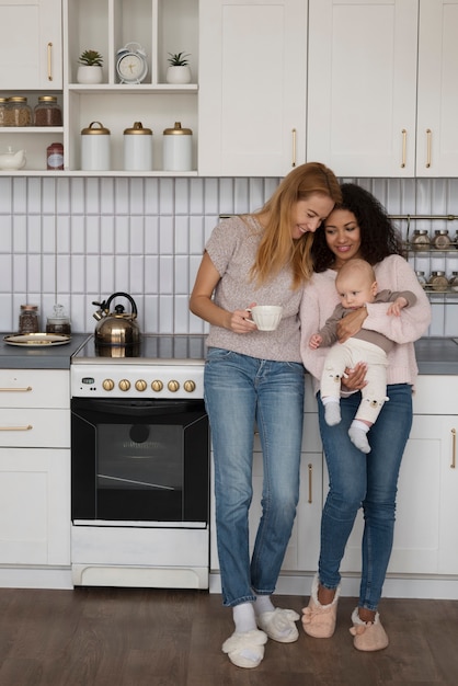 Photo family of two mums having a baby