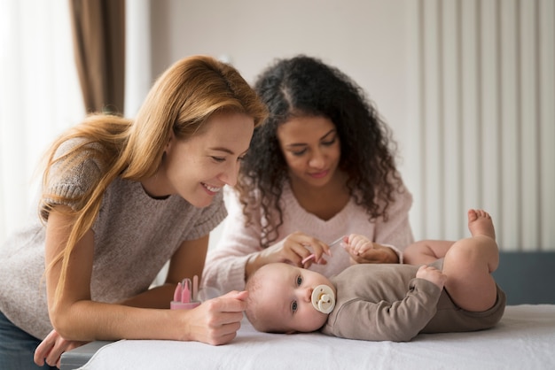 Photo family of two mums having a baby