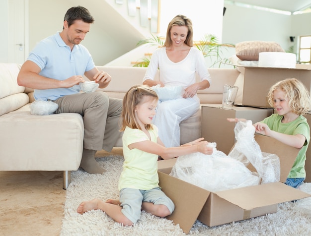 Family unpacking cardboard box