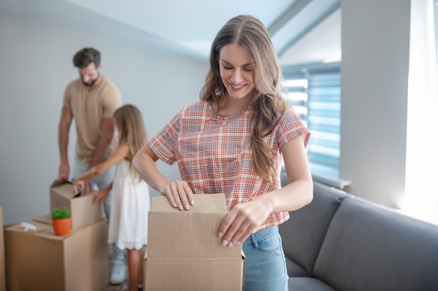 Family unpacking their stuff in a new house