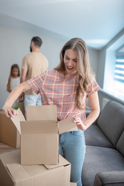 Family unpacking their stuff in a new house