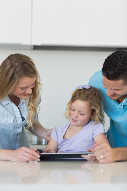 Photo family using tablet computer at table