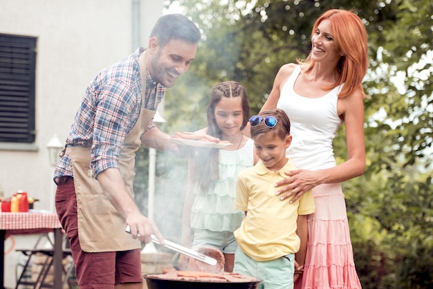 Family on vacation having barbecue