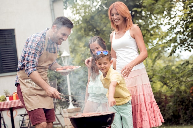 Family on vacation having barbecue