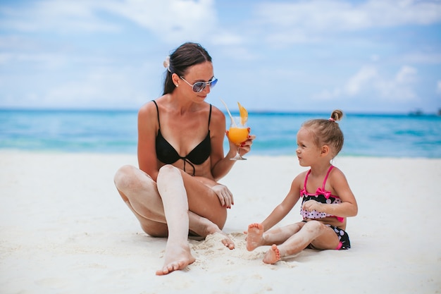 Family vacation. Mother and little daughter on vacation on the beach