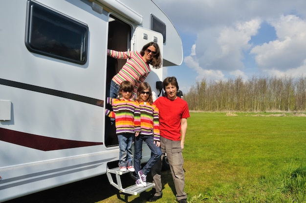 Photo family vacation, rv (camper) travel with kids, happy parents with children have fun on holiday trip in motorhome