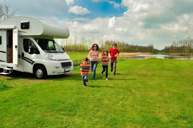 Family vacation, RV travel with kids, happy parents with children have fun on holiday trip in motorhome