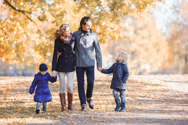 Family walk in autumn park