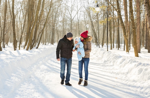 Family walk in a winter park. Baby and mother and father