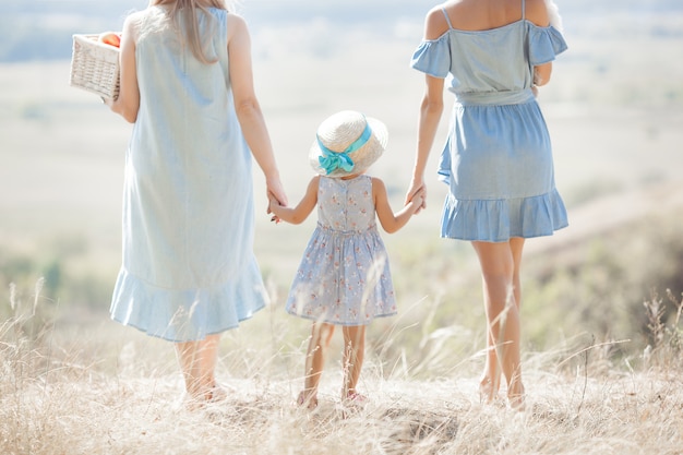 Family walking on a field outdoors