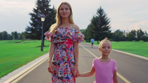 Family walking in garden Mother and daughter spending family weekend outdoor