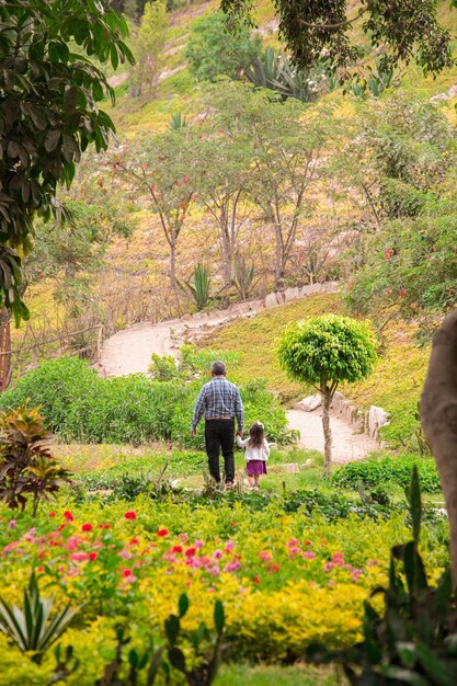 Family walking holding hands on a park in Peru