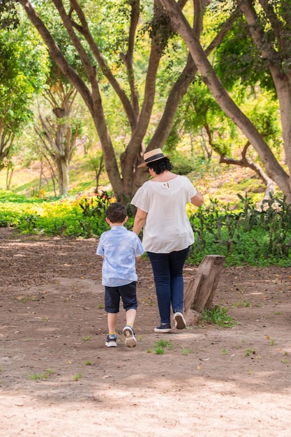 Family walking holding hands on a park in Peru