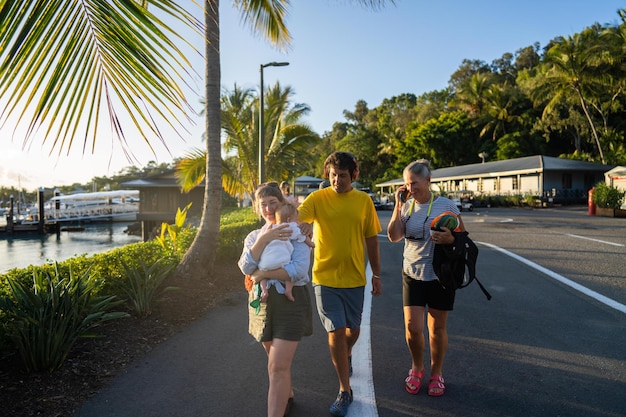 A family walks down the road with a baby.