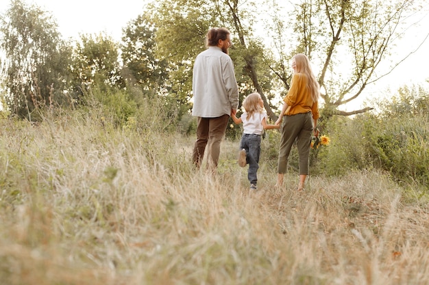 The family walks in nature and leaves. free space for text