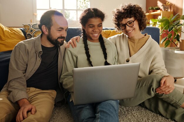 Family watching video on laptop at home