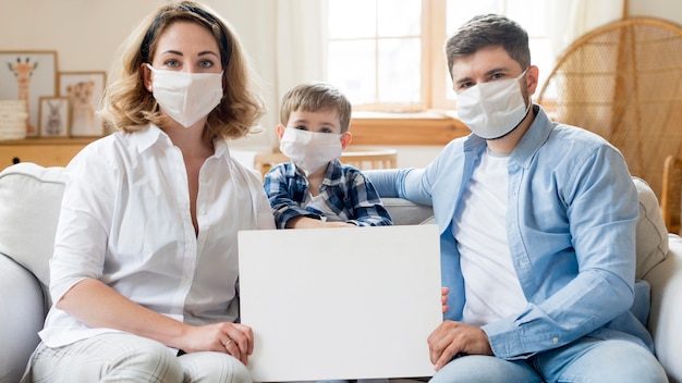 Photo family wearing medical masks indoors
