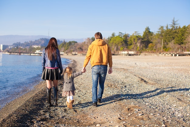 Family at wild beach during the warm winter