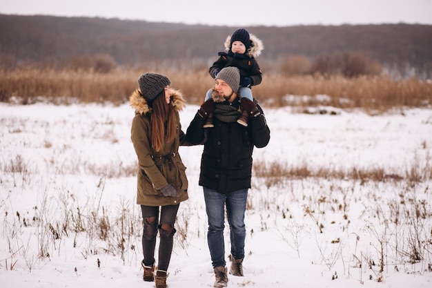 Family in winter in forest with son