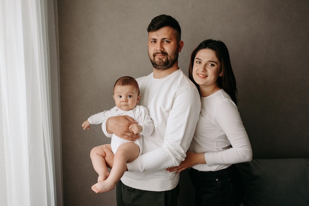 A family with a baby in their arms