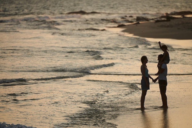 Family with Child Staning on Beach