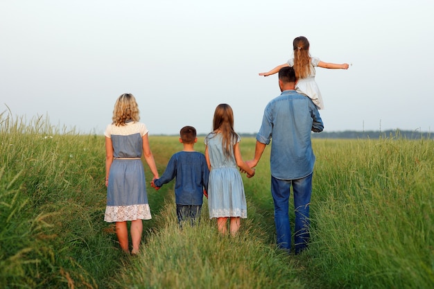 Family with children near the field concept together relationship