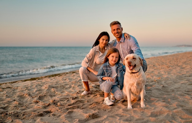 Family with dog on the beach