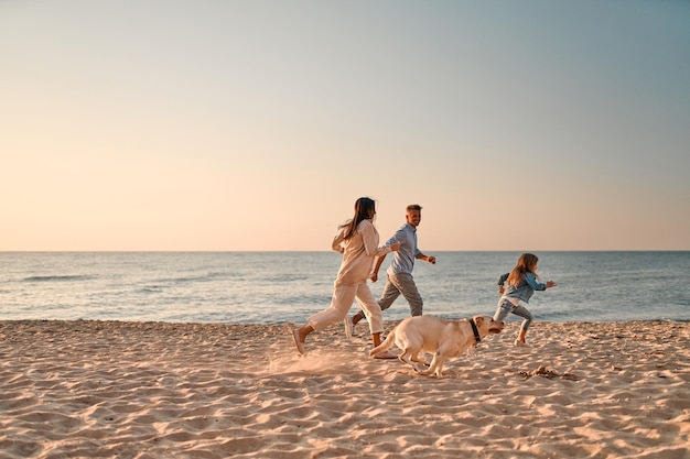 Family with dog on the beach