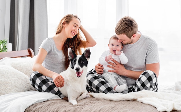 Family with dog in the bed