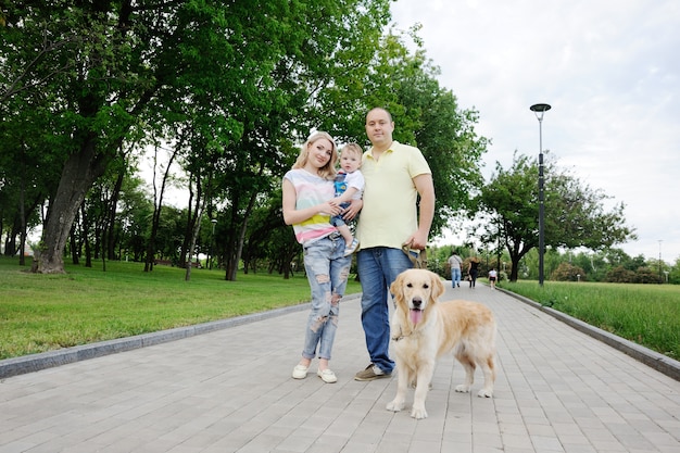 Family with a gold retriever dog at the park