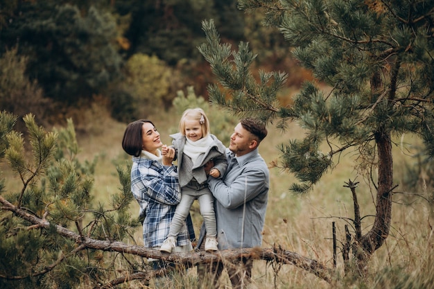 Family with little daughter together in autumnal weather having fun