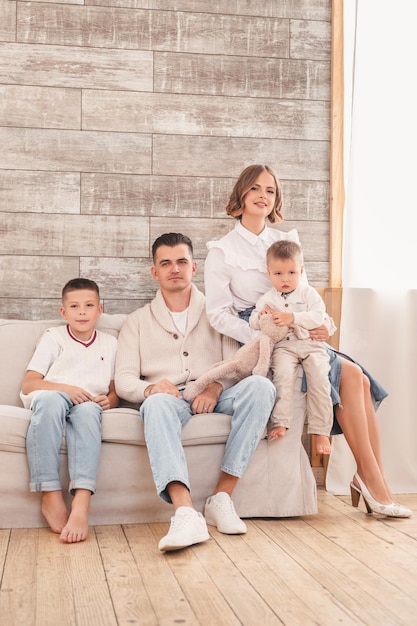 family with two sons sitting on the sofa