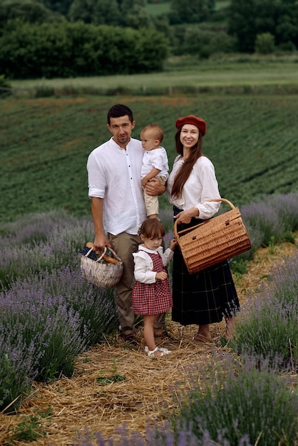 A family with two wonderful children walks on a lavender field.