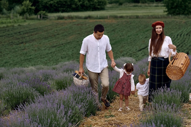 A family with two wonderful children walks on a lavender field.