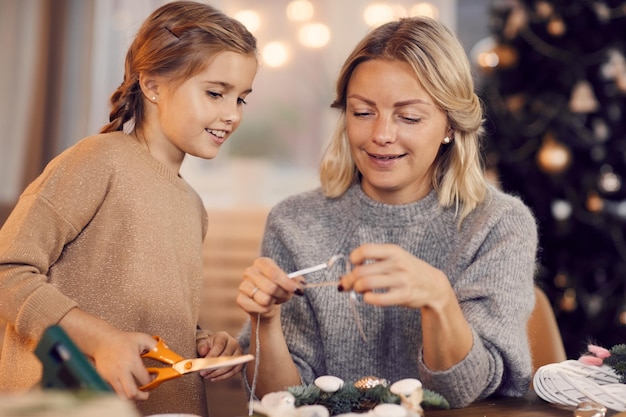 Family working on Christmas wreath