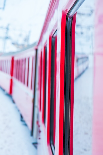 The famous Bernina red train, Unesco monument, in the middle of a winter storm