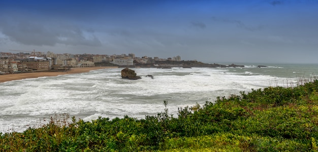 Famous Biarritz beach (Pays Basque, France) with ocean waves, bad weather