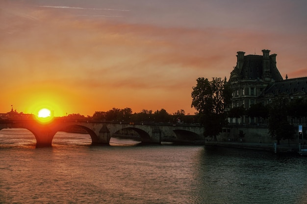 The famous bridge called Pont Royal and the Louvre Museum at sunset Paris