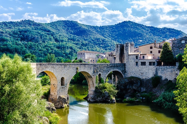 Famous medieval bridge over the river Fluvia in the medieval village de Besal Girona Catalonia