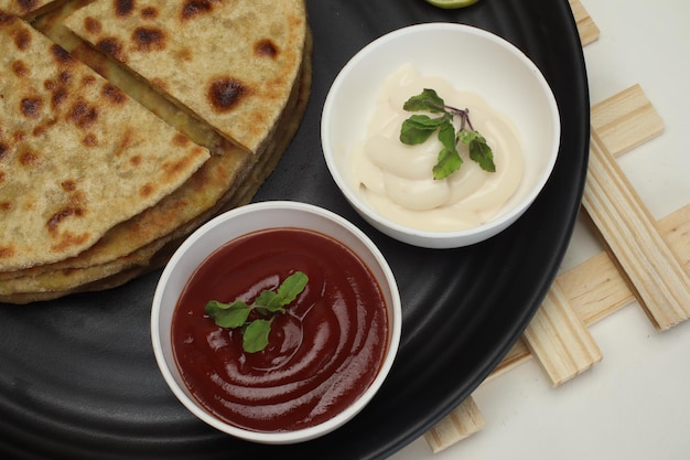 Famous punjabi Indian food Aloo paratha or potato stuffed flat bread. served with tomato ketchup