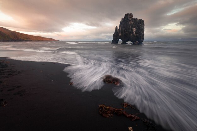 Photo famous rhino rock named hvitserkur next to osar in north iceland.