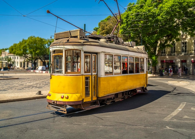 Famous and typical old yellow Portuguese tram beautifully decorated and preserved running