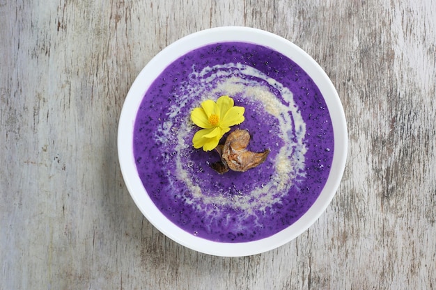 Famous Ube Champorado served in dish isolated on wooden background top view of breakfast