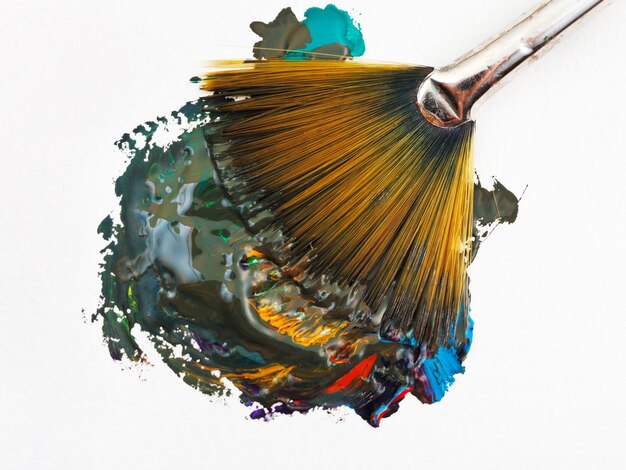 Fan paintbrush blends multicolored watercolors